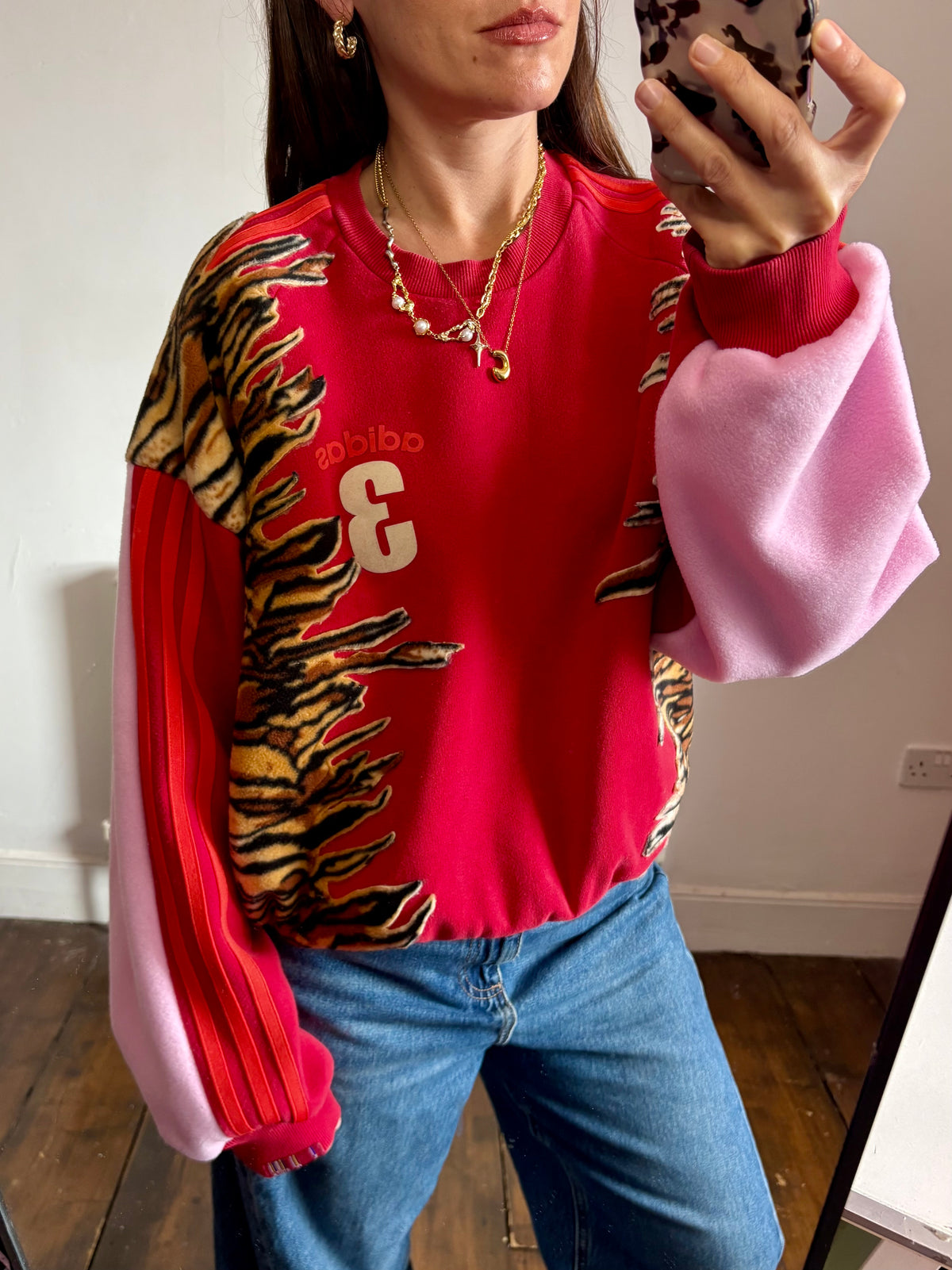Y2K red adidas tiger print and pink fleece patchwork sweatshirt.