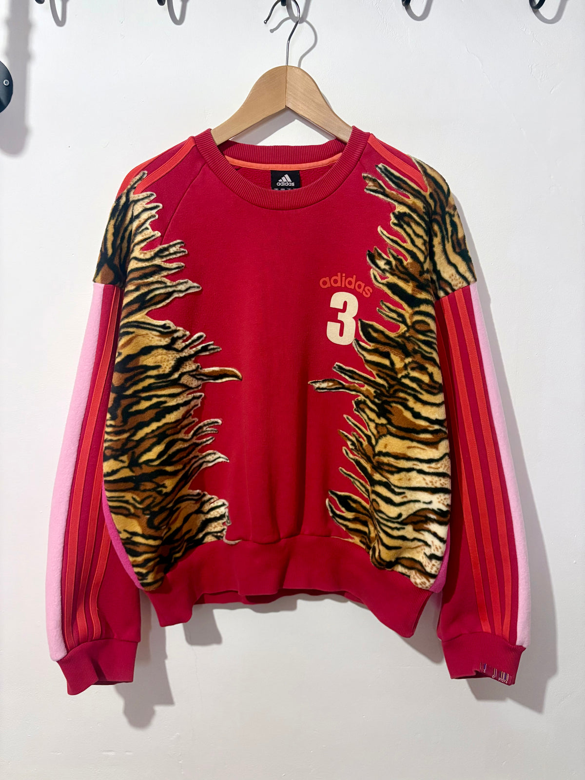 Y2K red adidas tiger print and pink fleece patchwork sweatshirt.