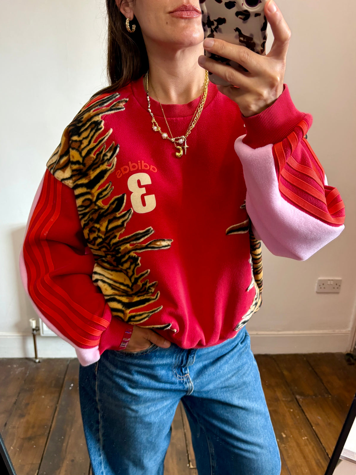Y2K red adidas tiger print and pink fleece patchwork sweatshirt.