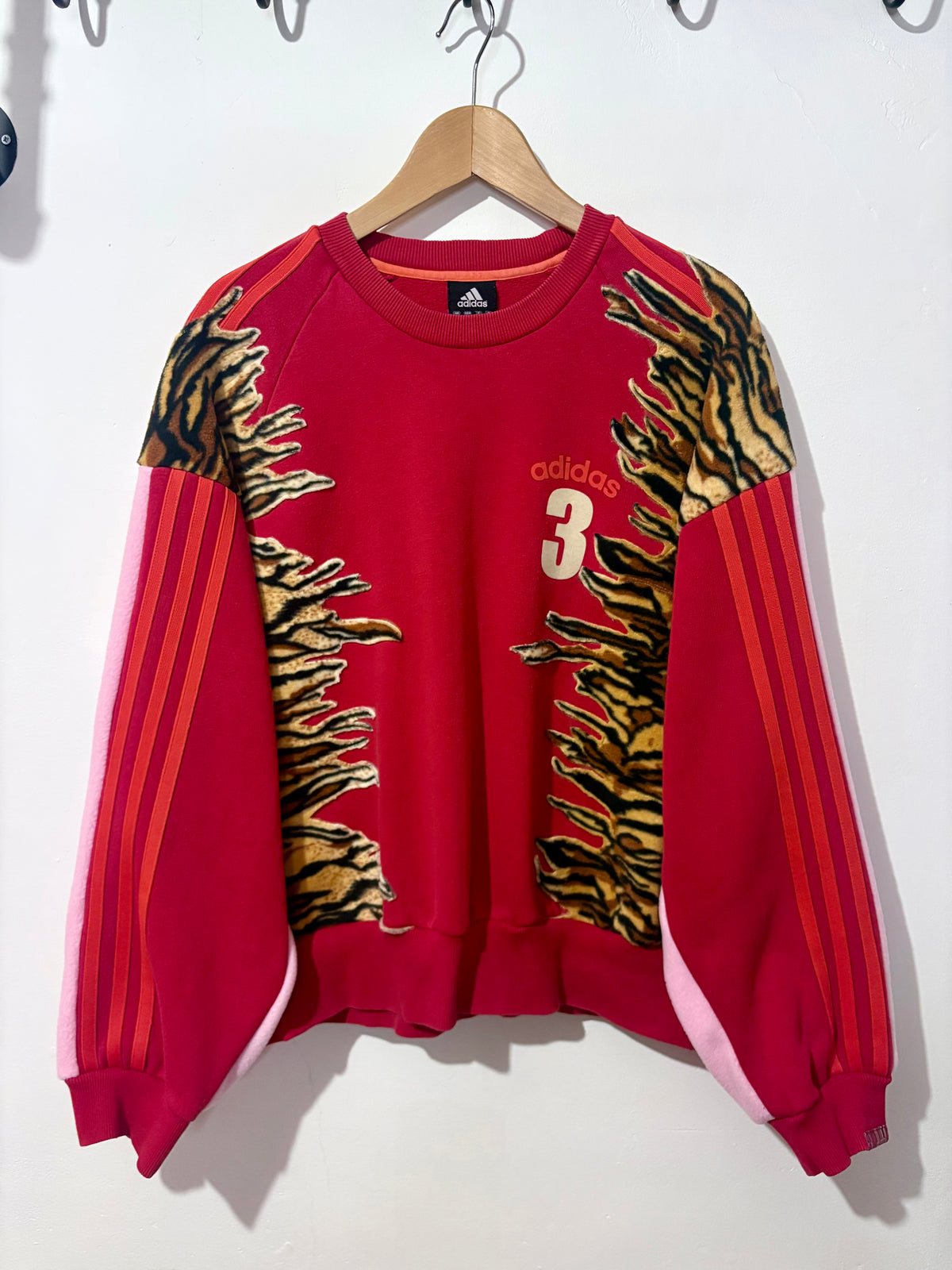 Y2K red adidas tiger print and pink fleece patchwork sweatshirt.