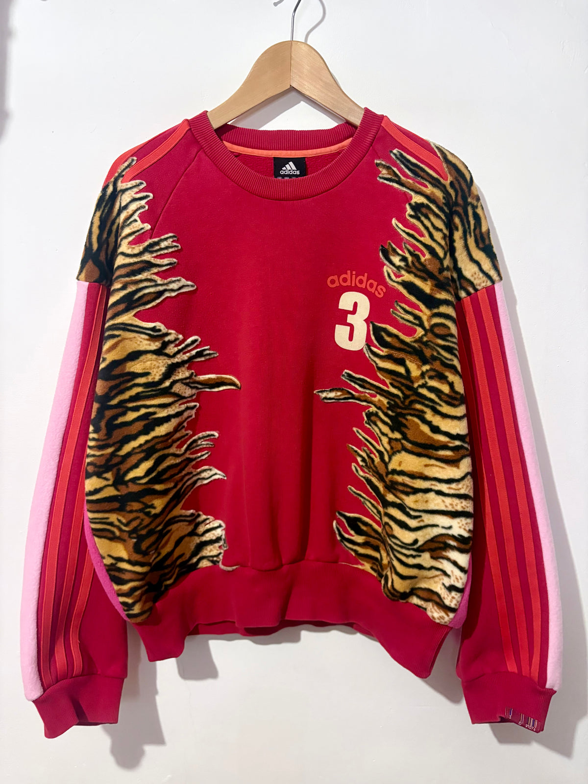 Y2K red adidas tiger print and pink fleece patchwork sweatshirt.