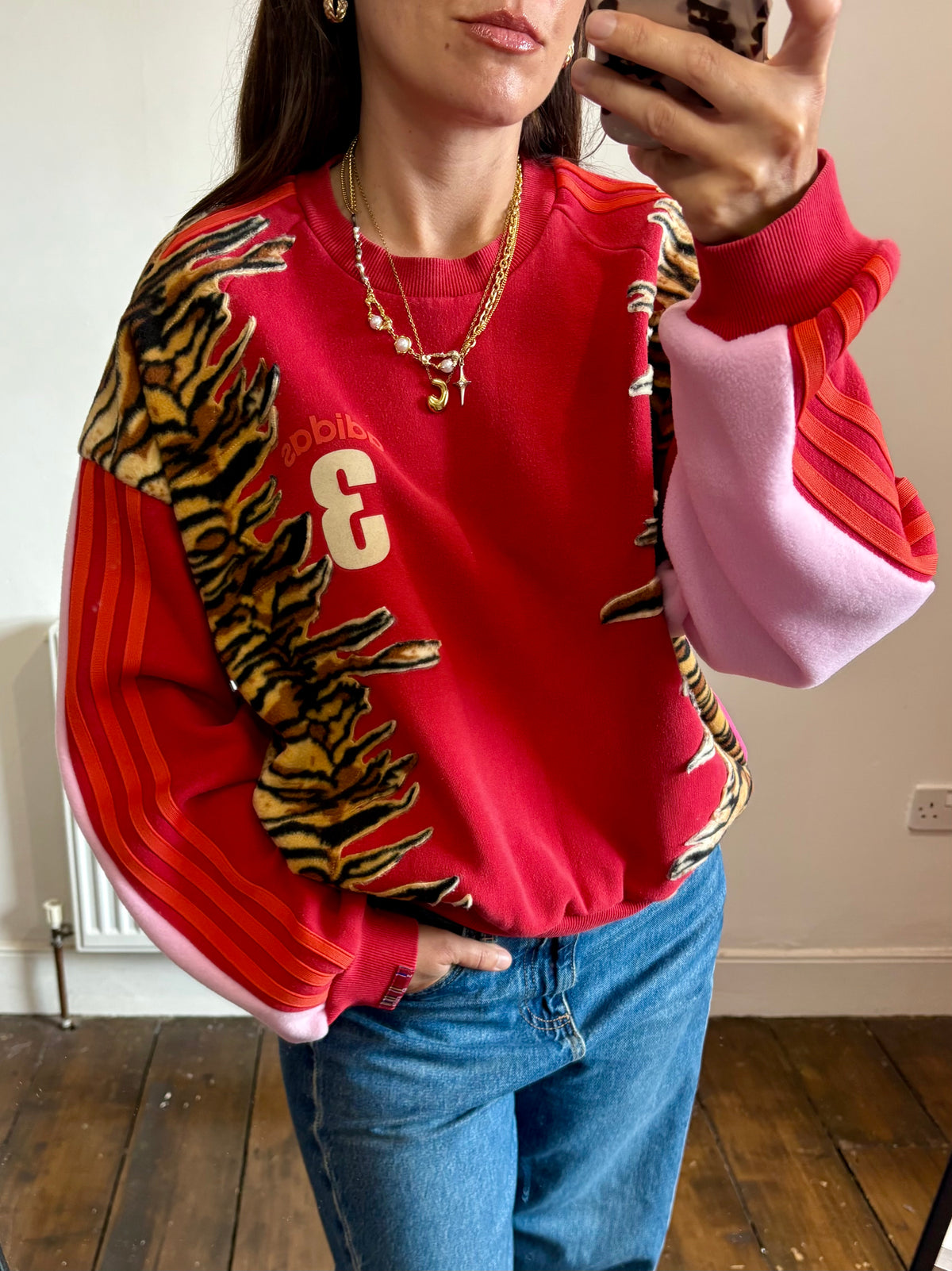 Y2K red adidas tiger print and pink fleece patchwork sweatshirt.