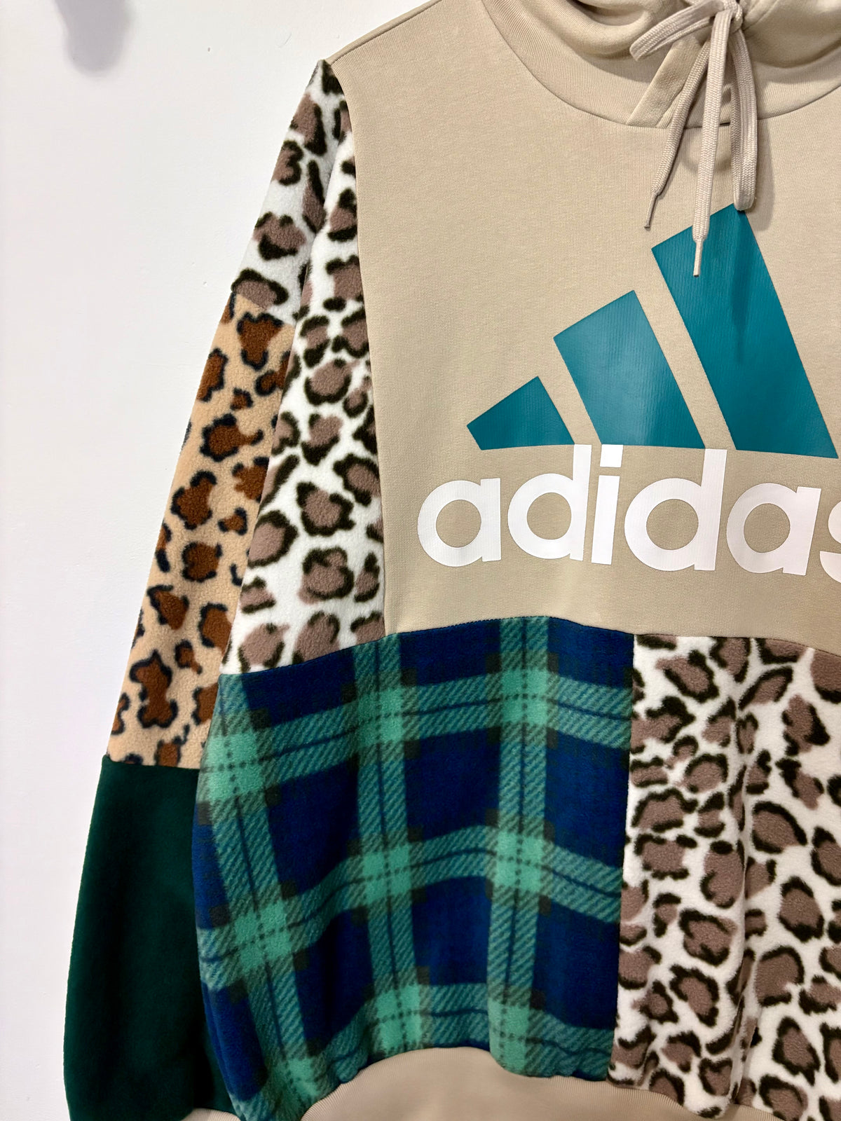Y2K beige adidas logo clashing checked tartan and leopard print patchwork hoodie sweatshirt.